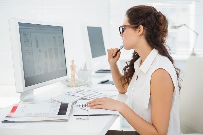 Concentrated businesswoman using computer monitor in the office Concentrated businesswoman using computer monitor in the office